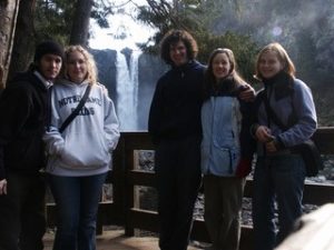 people standing in front of a waterfall