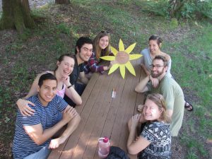 People smiling at a picnic table