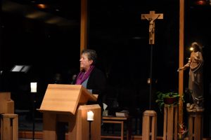 woman speaking at church altar