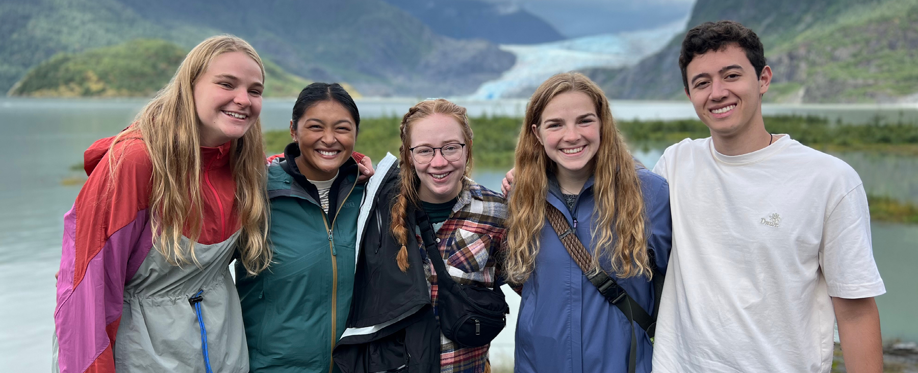 Five JVs smiling in front of Mendenhall Glacier in Juneau ,AK